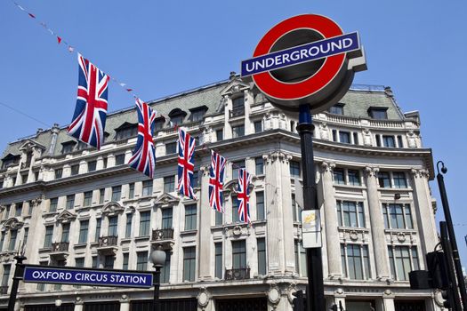 London Underground sign and Union Flags at Oxford Circus station.