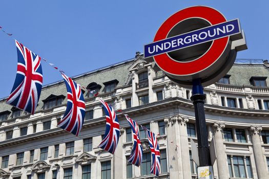 London Underground sign and Union Flags in London.