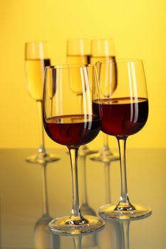 Glasses with wine on the color background