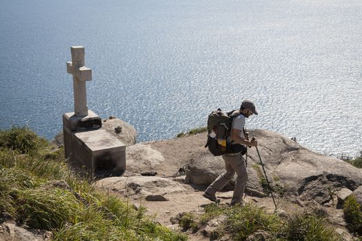 FINISTERE, SPAIN – SEPTEMBER 4:  Unidentified pilgrim at the end of his Camino de Santiago walk on September 4, 2012. Here he will burn his clothes and boots and throw the ashes into the sea.