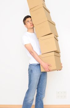 Young man carrying a stack of boxes