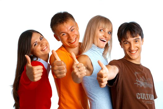 Four young people on white background laughing and giving the thumbs-up sign. 
