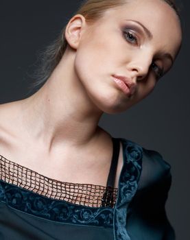 Close-up portrait of a beautiful model dressed in vintage blouse, posing.