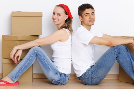 Young couple resting from moving into a new home