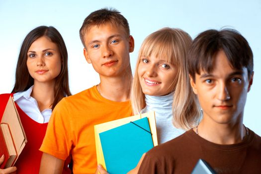  Casual group of college students smiling stand in a row with books on white 