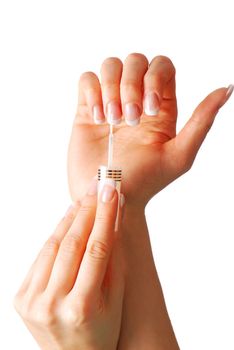 Woman applying white nail polish