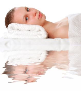 Woman laying on towel over white                