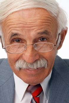 Close-up portrait of a happy elder businessman in the glasses.