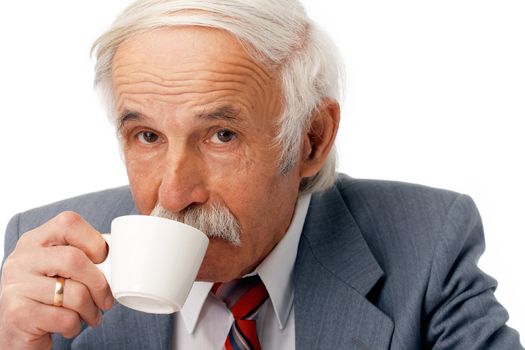 Portrait of an elder businessman drinking coffee over white.