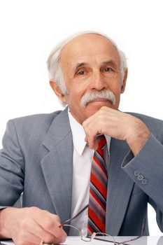 Close-up portrait of an elder businessman sitting thoughtful over white.