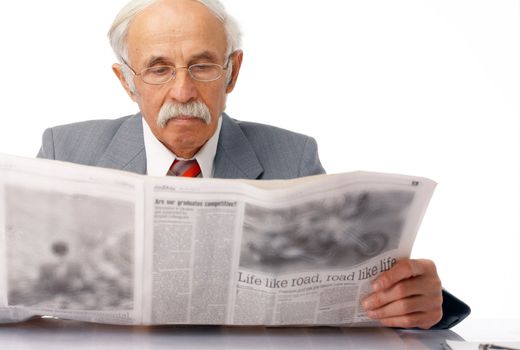 Elder man sitting and reading a newspaper over white.