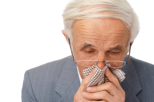 Portrait of an elder man using his handkerchief over white.