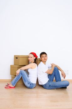 Young couple resting from moving into a new home. Great copy space.