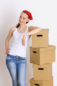 Young woman with a stack of boxes