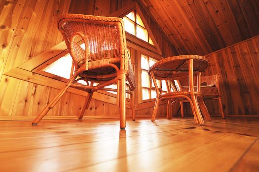 Wooden interior with wicker furniture