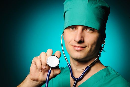 Doctor holding stethoscope over blue background