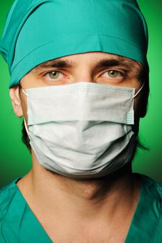 Surgeon in mask over green