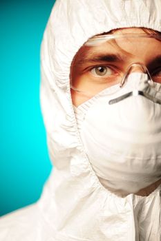 Scientist in protective wear, glasses and respirator 