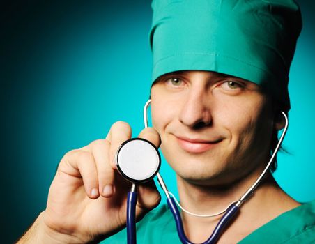 Doctor holding stethoscope over blue background