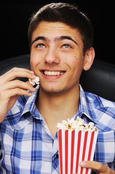 Young man watching movie at cinema