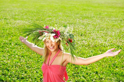 Girl wearing a wreath made from flowers with outstretched arms