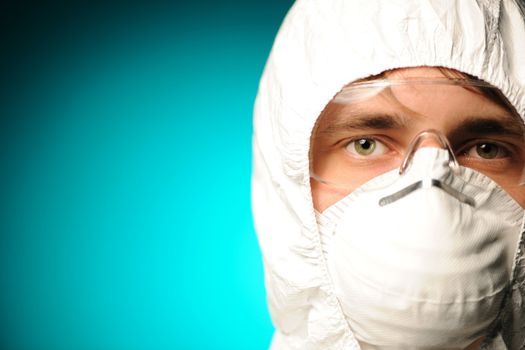 Scientist in protective wear, glasses and respirator 