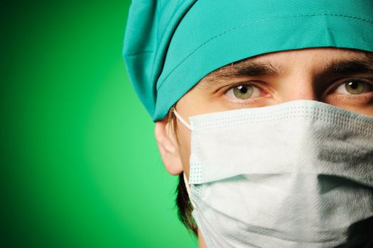 Surgeon in mask over green