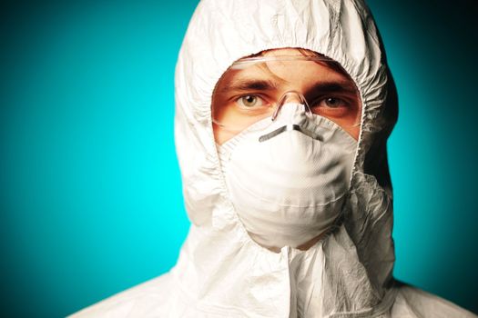 Scientist in protective wear, glasses and respirator 