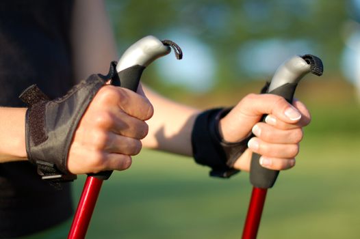 Closeup of woman's hands holding nordic walking poles