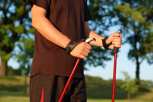 Closeup of man's hands holding nordic walking poles