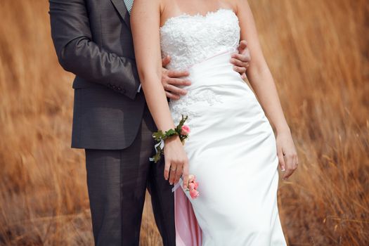bride and groom in the field 