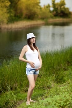 young fashion pregnant girl outdoors