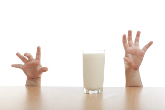 two hands over the table and glass of milk