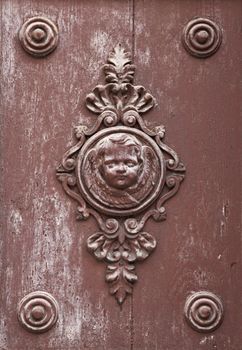 Wooden ornament on a historic church door in Zadar, Croatia