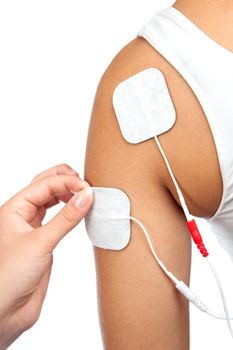 electrodes of tens device on shoulder, tens therapy, nerve stimulation