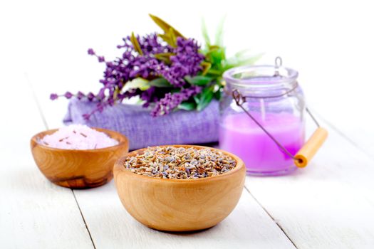 dry Lavender herbs, bath salt and candle, on white wooden table