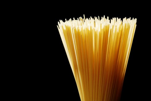 Spaghetti straws arranged isolated on black