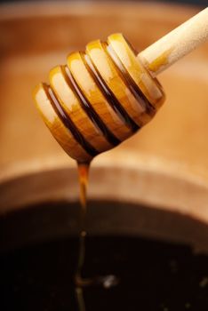 Dense honey in a wooden bowl showing purity