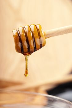 Bright honey drizzling from a traditional dripper