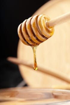 Sticky honey clinging onto a wooden stick