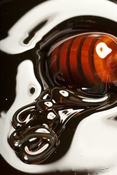 Thick honey producing abstract forms with a wooden drizzler