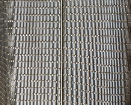 Abstract metal grid wall that is part of a city light rail stop