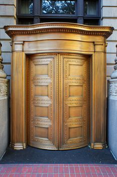 Large curved brass closed doors on a bank entrance