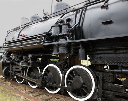 Old Black Steam Locomotive Train with closeup of wheels and boiler