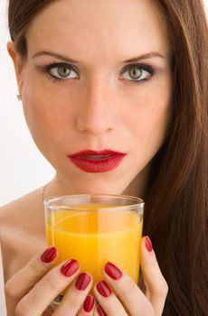 Colorful Woman's hand holds a glass of Orange Juice