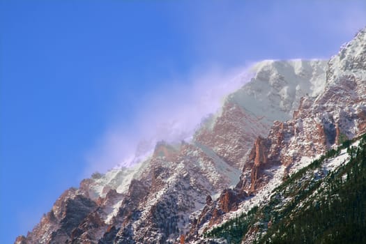 Intense winds create a fog of snow over Mount Chapin of Rocky Mountain National Park in Colorado.