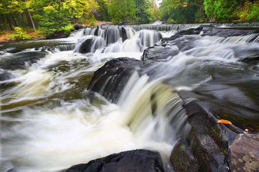 Beautiful Bond Falls flows through the forests of northwoods Michigan.