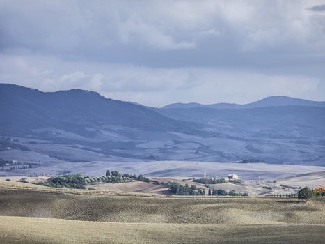 tuscan mountain range and field