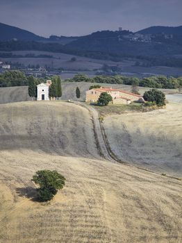 tuscany mountain range and field