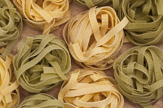 Green and yellow taglatelle nests.